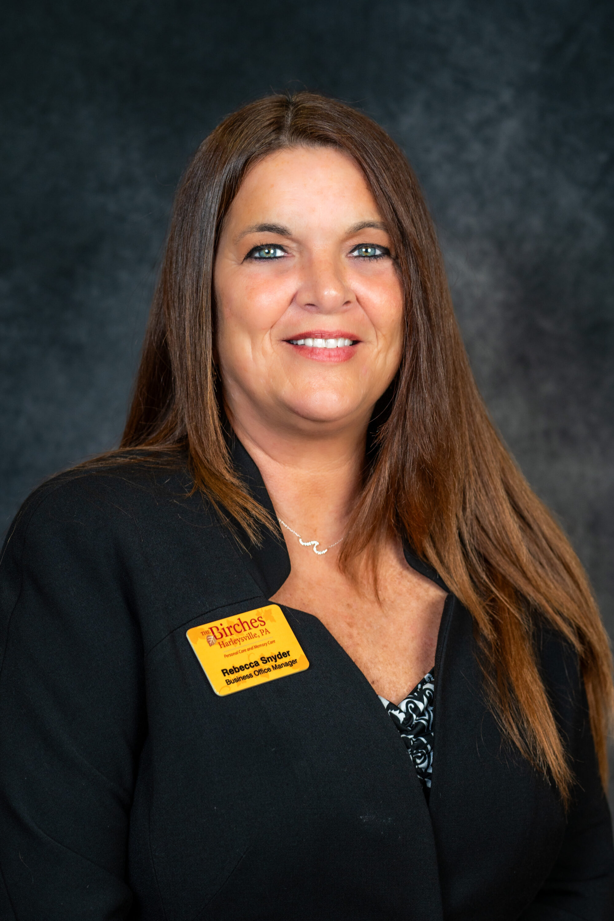 Professional woman wearing name badge in studio portrait