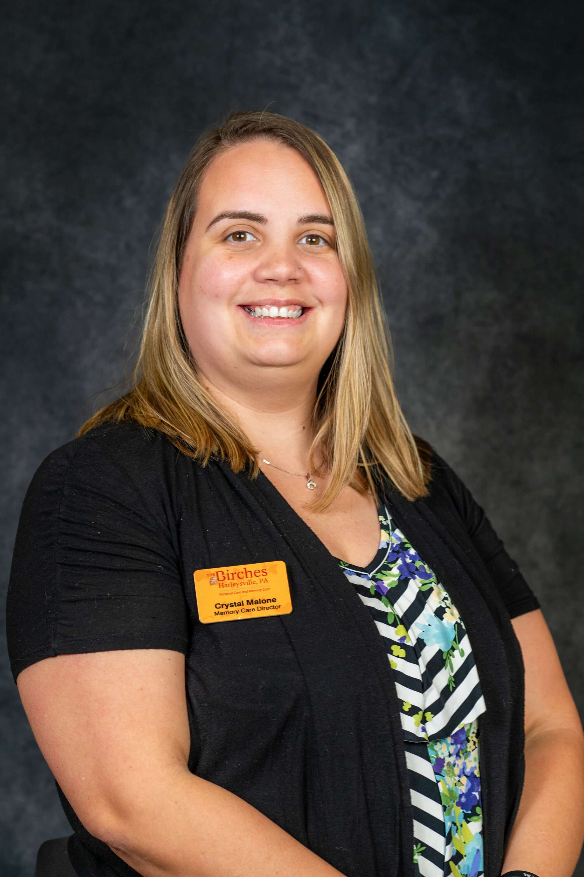 Professional woman wearing name badge in studio portrait