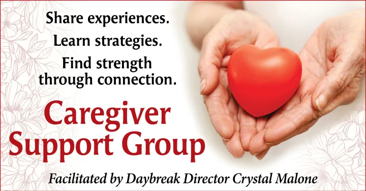 Hands holding red heart for caregiver support group