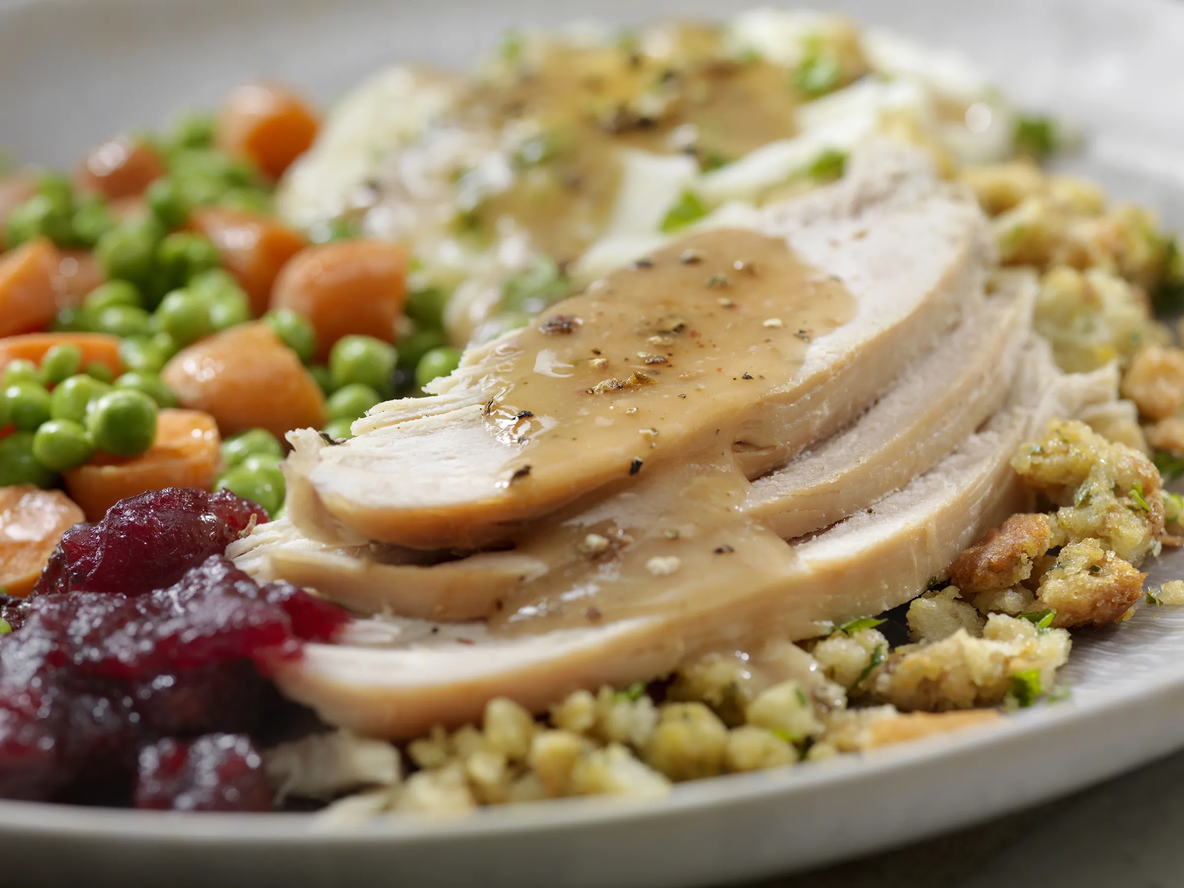 Sliced turkey with gravy and classic side dishes